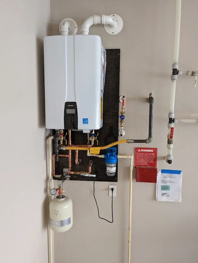 Professional plumber installing copper piping in a Grand Junction home